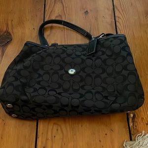 Black coach purse with three compartments